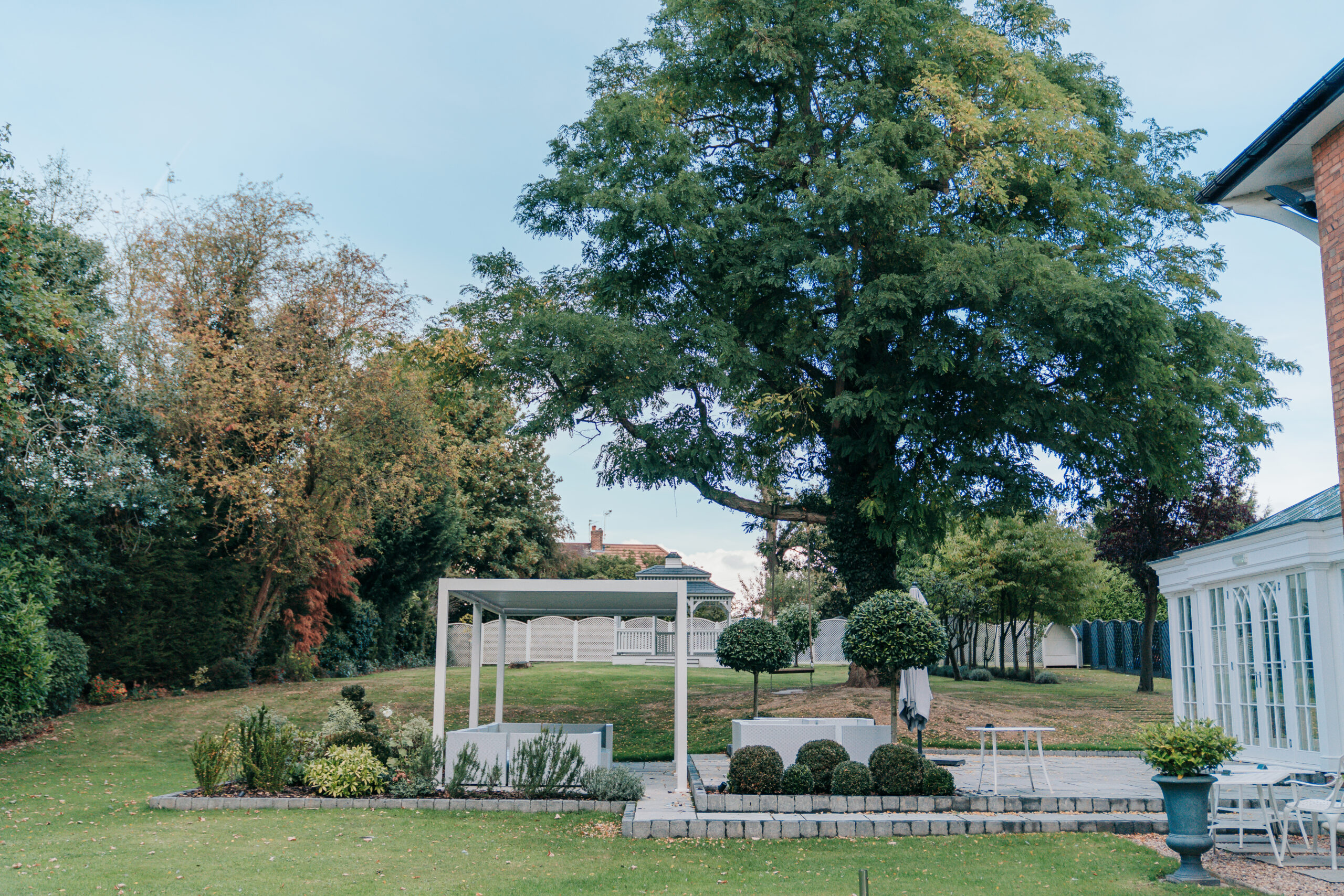 Garden with trees and modern garden room.