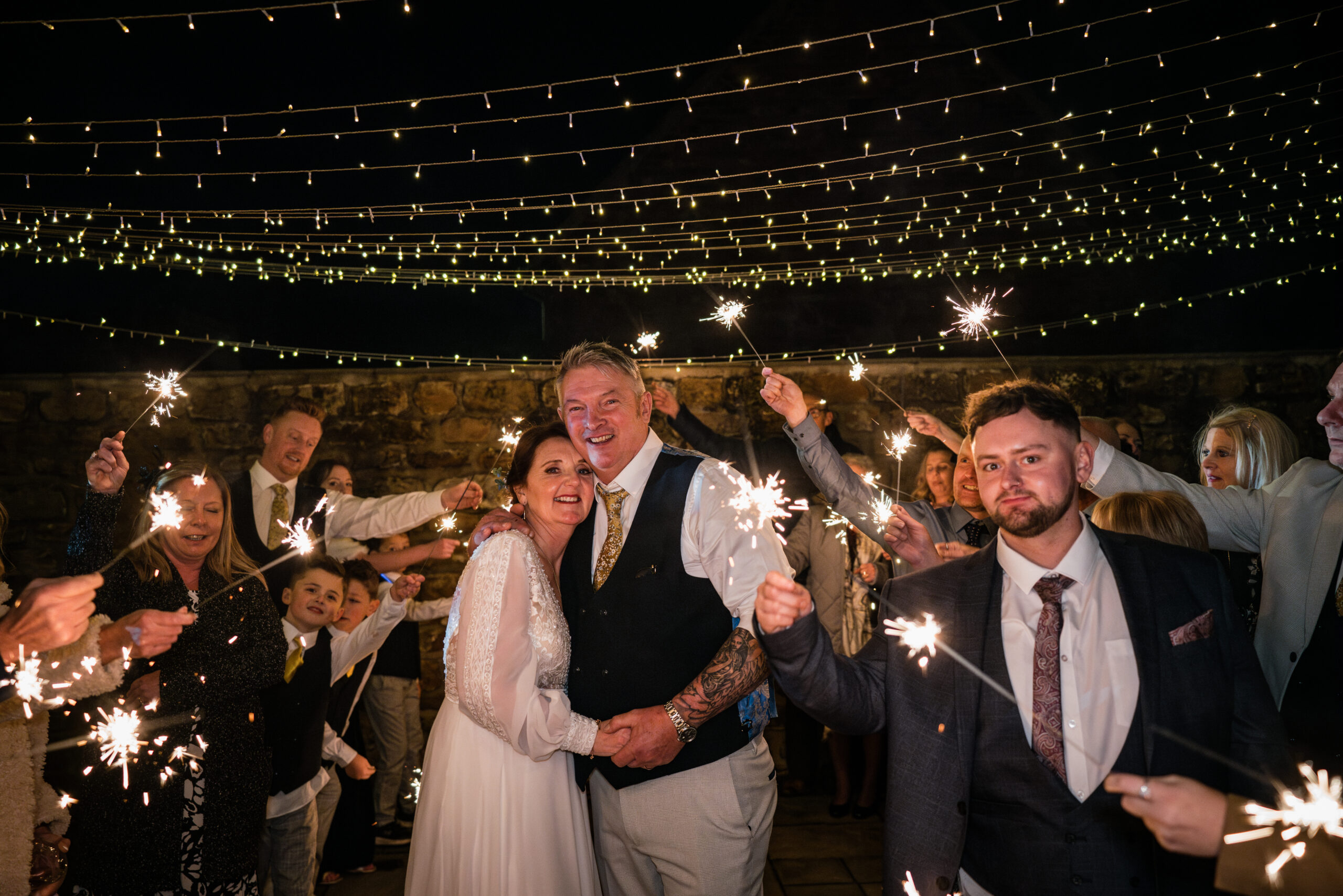 Wedding celebration with sparklers and fairy lights.