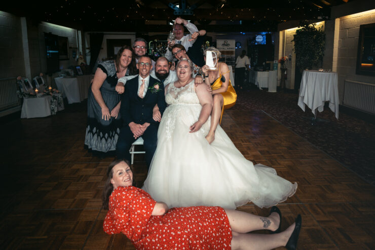 Smiling wedding guests posing for a fun photo.