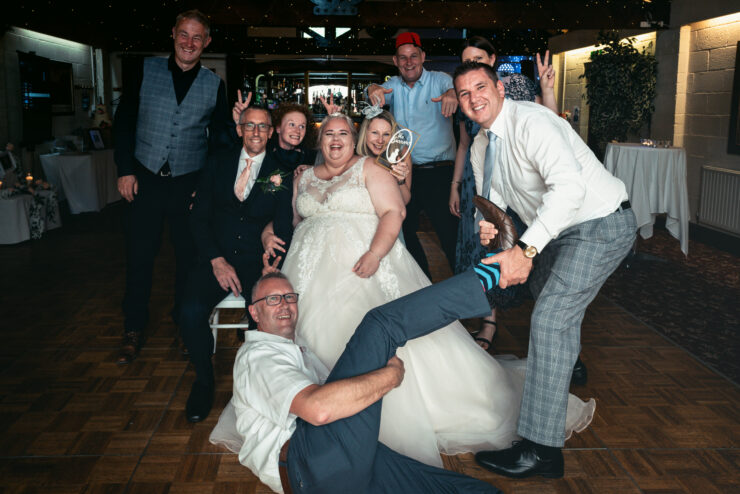 Group of people celebrating at a wedding reception.