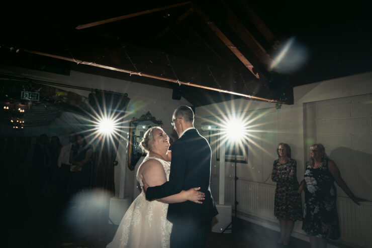 Bride and groom dancing at wedding reception.