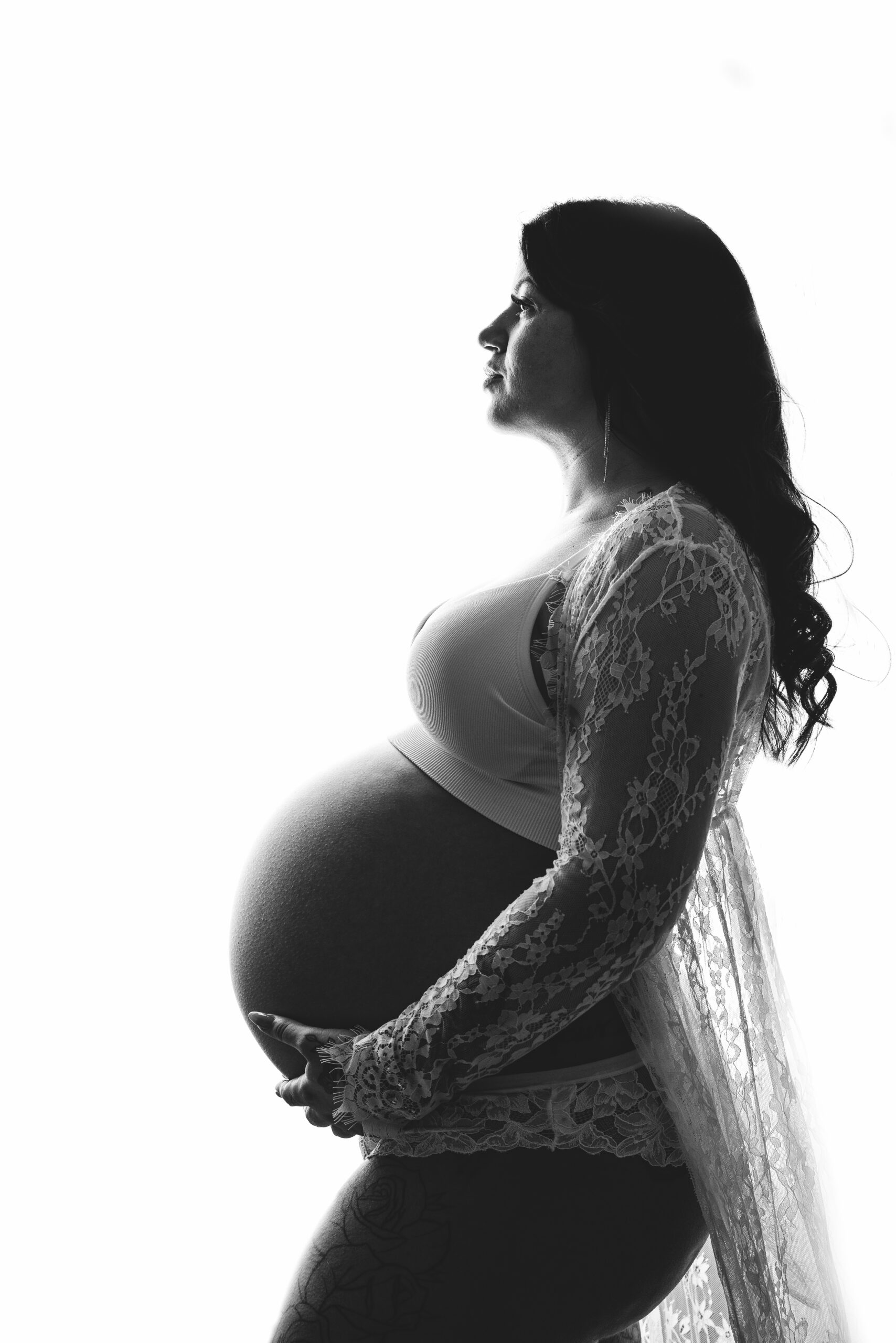 Pregnant woman in lace robe silhouette