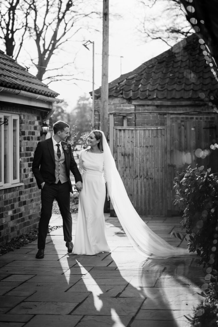 Bride and groom walking happily after wedding ceremony.