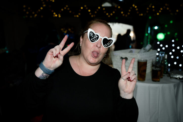 Woman posing with peace signs at party