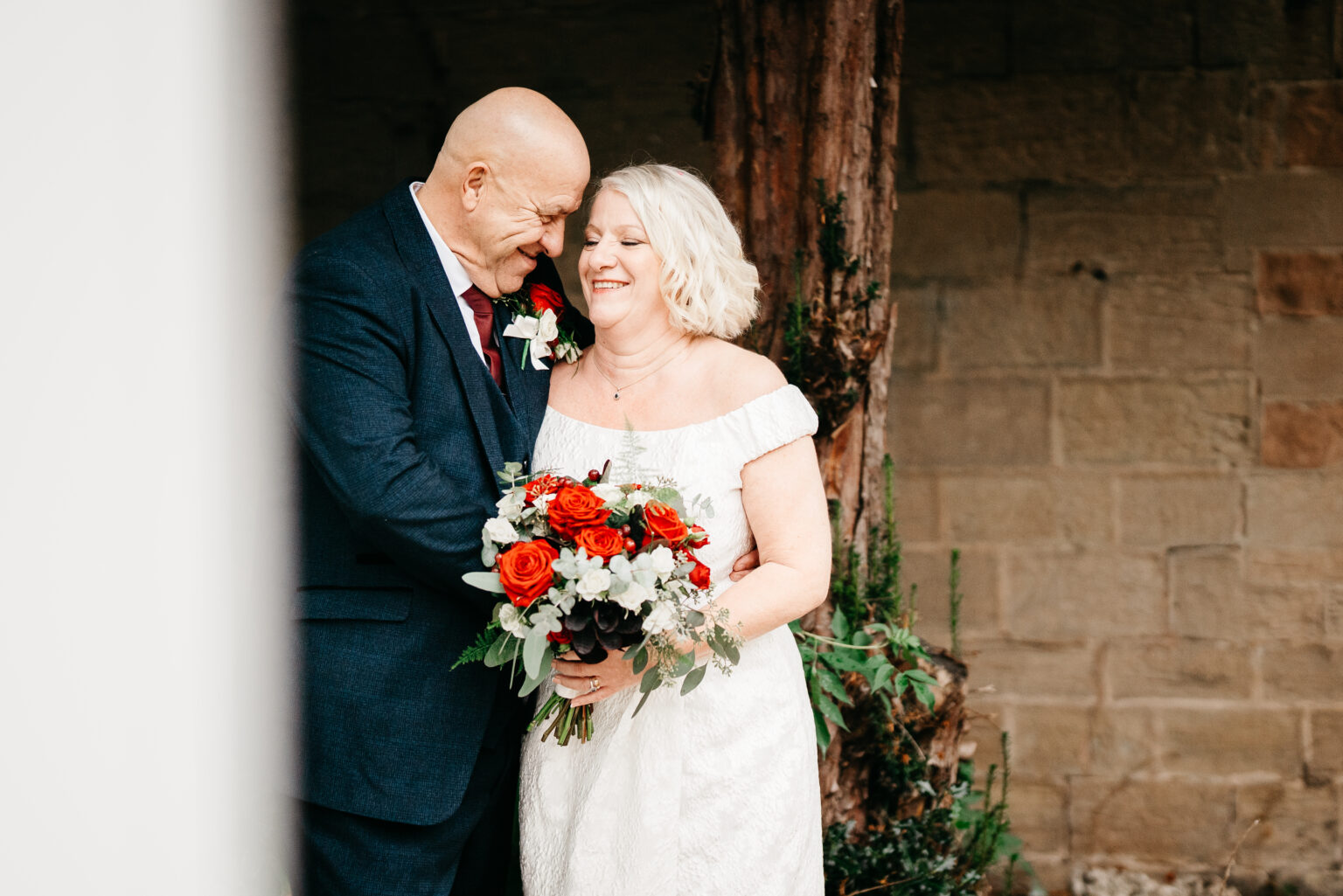 Happy couple with a bridal bouquet