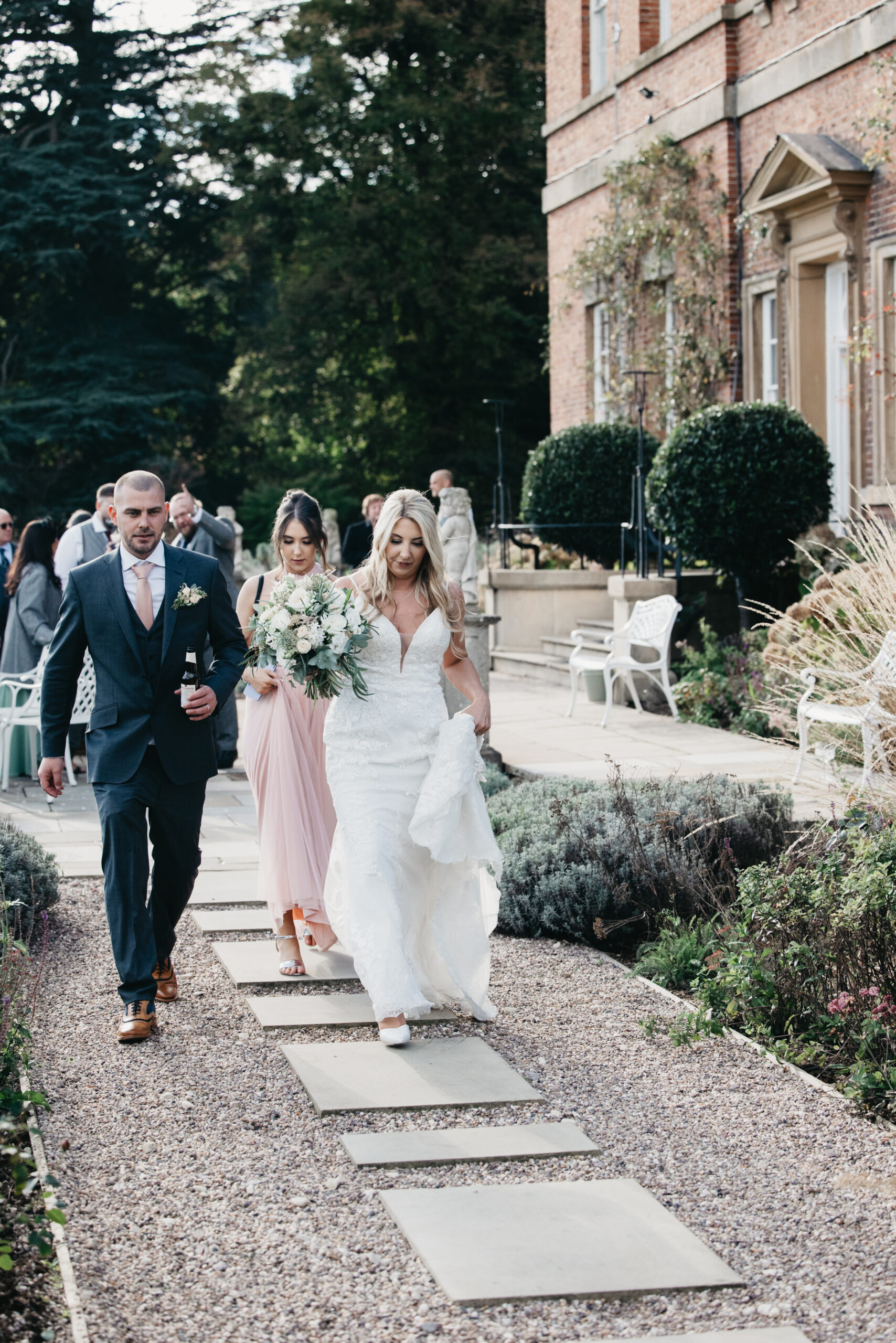 Bride and guests walking outside venue