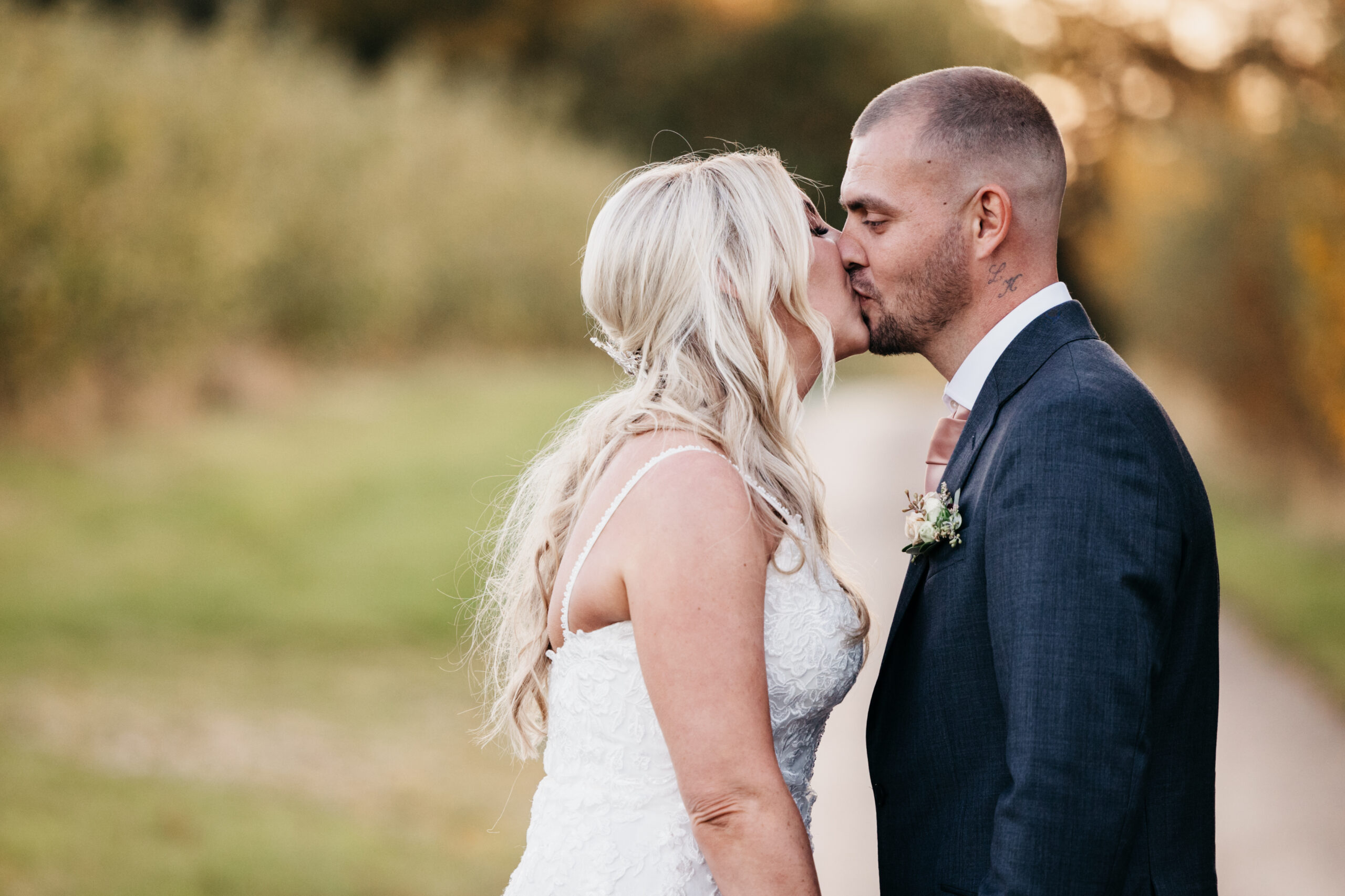 Bride and groom kissing in the countryside
