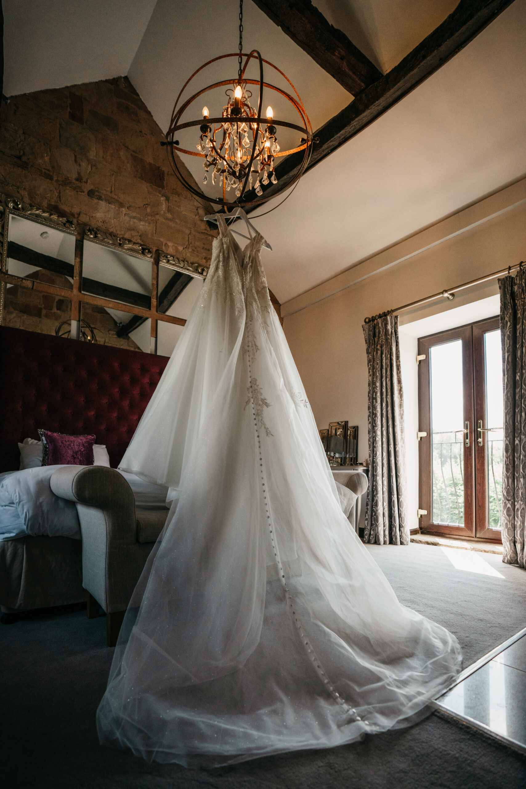 Elegant bridal gown hanging in hotel room