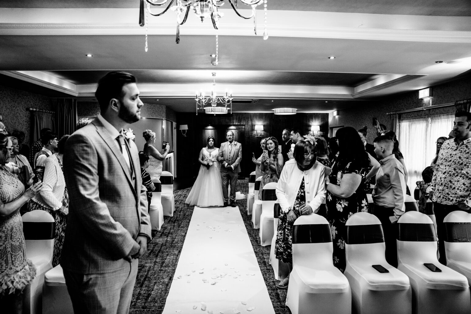 Bride walking down aisle at wedding ceremony.