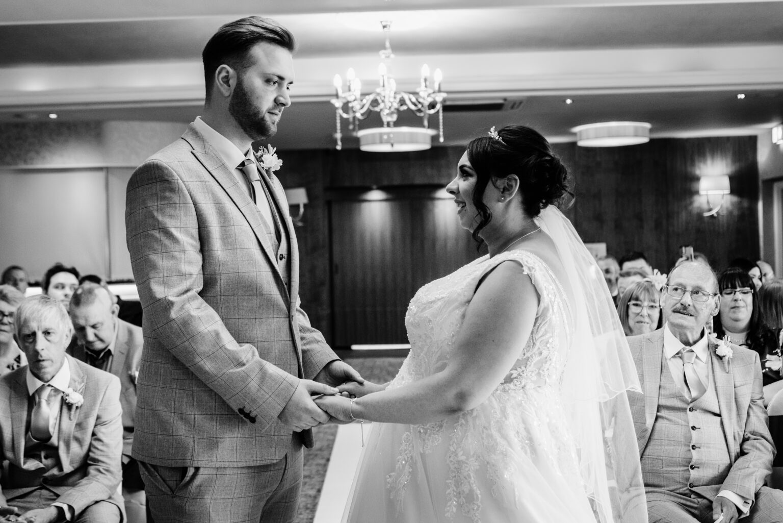 Bride and groom holding hands during ceremony
