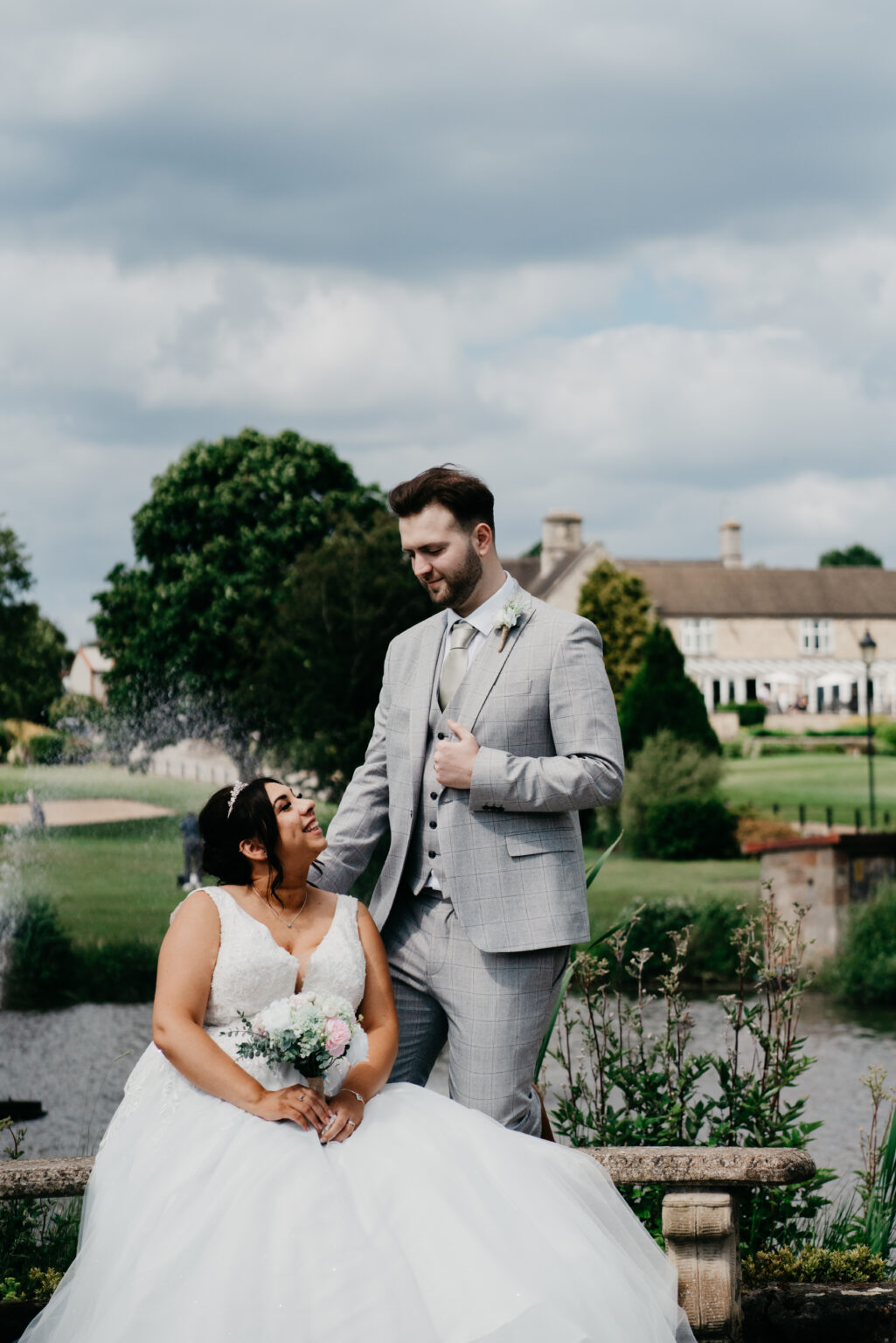 Bride and groom in garden, smiling blissfully together.