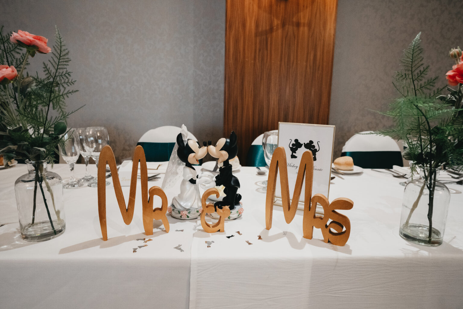 Wedding table with Mickey and Minnie figurines.