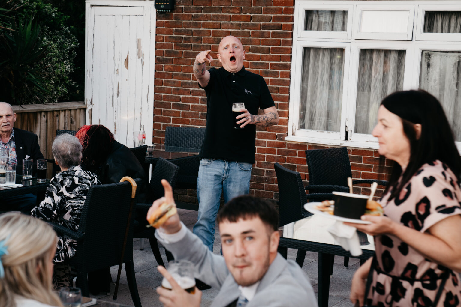 Outdoor gathering with people socialising and eating.