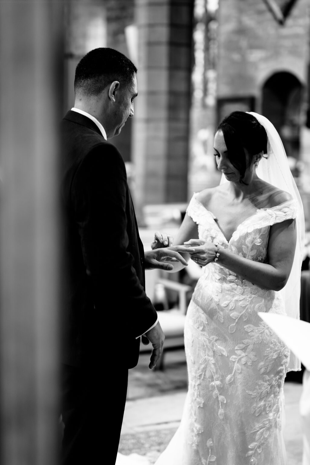 Bride places ring on groom's finger