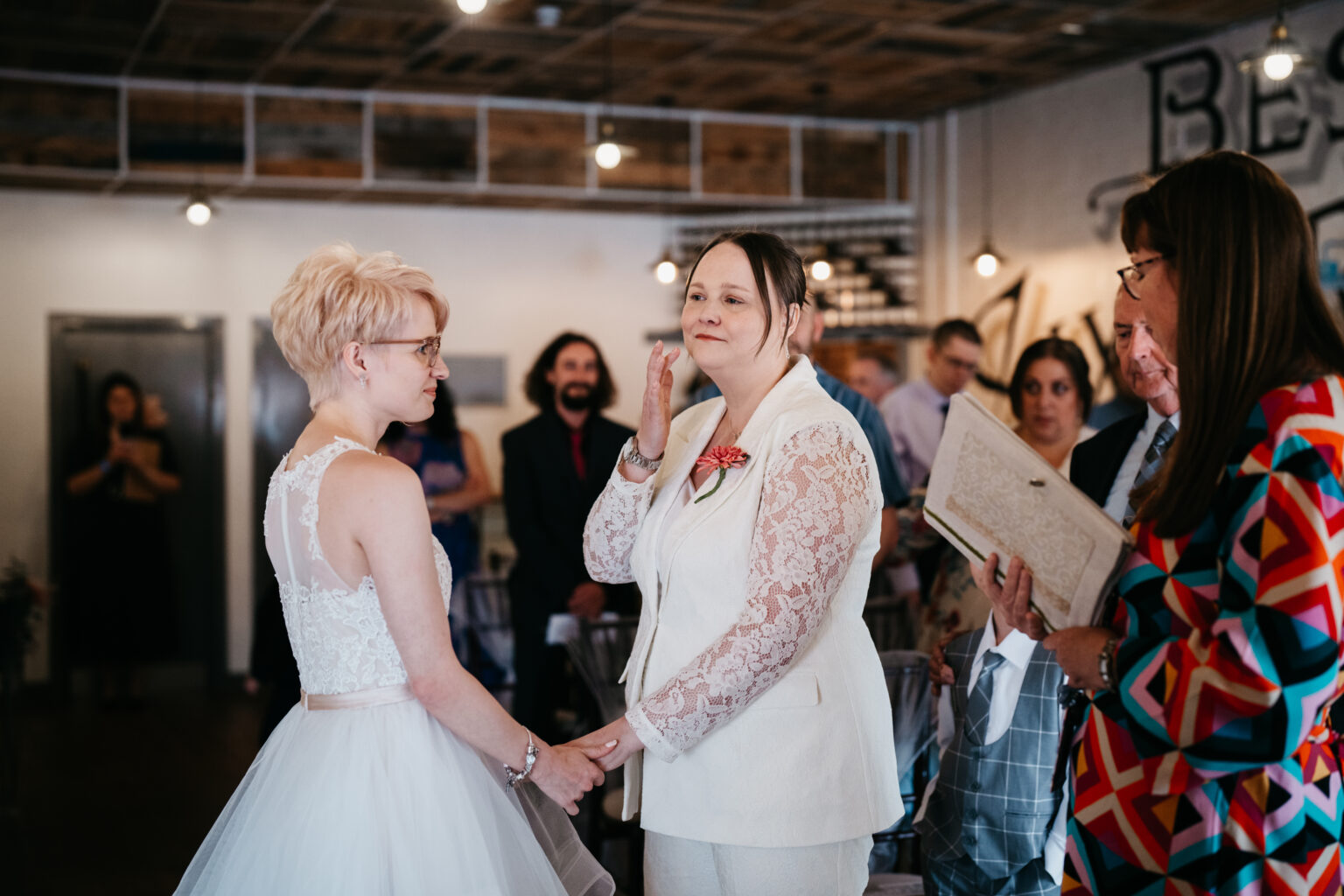 Couple exchanging vows at wedding ceremony indoors.