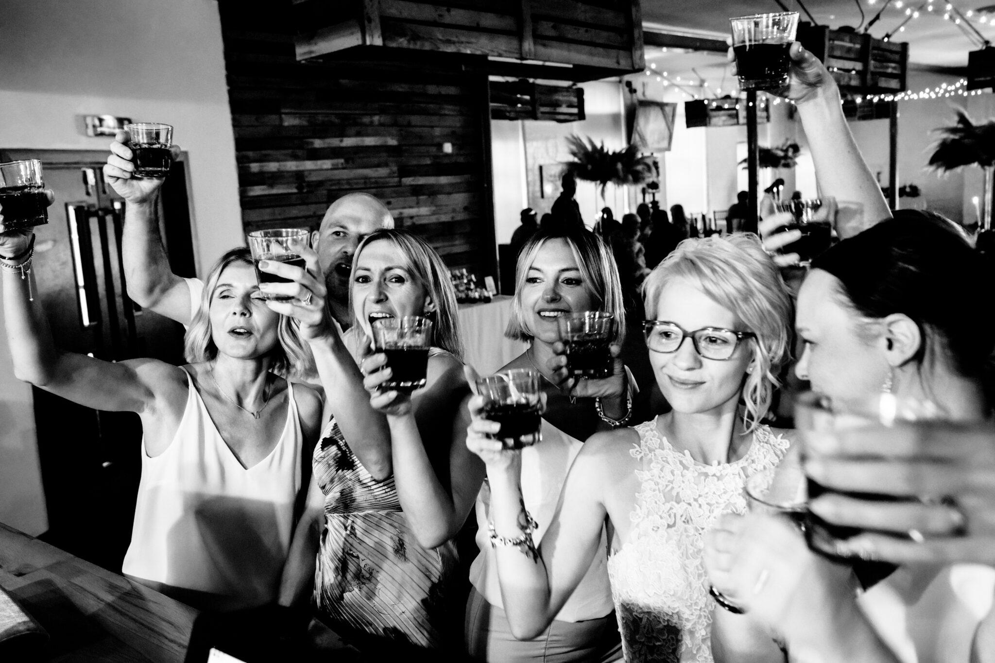 Group celebrates with drinks at party gathering.