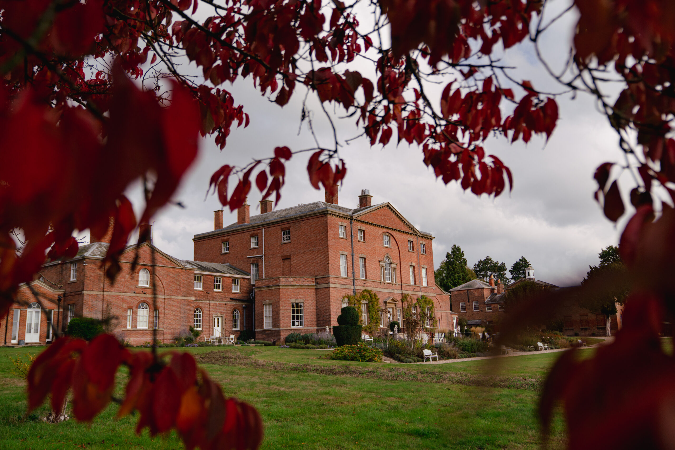 Historic brick mansion with autumn leaves