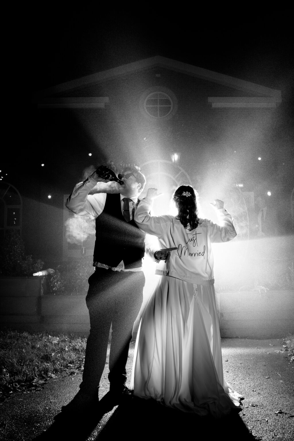Newlyweds celebrating with champagne at night.