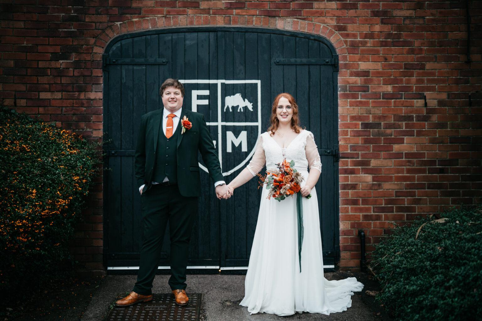 Bride and groom standing hand in hand
