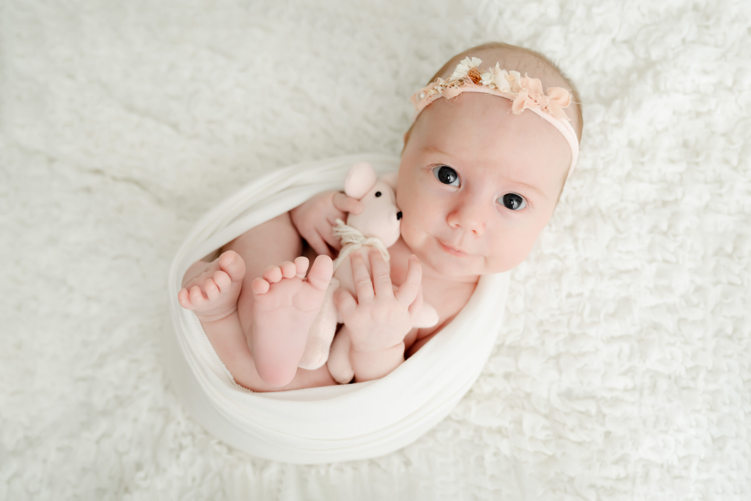 Newborn baby wrapped in white blanket
