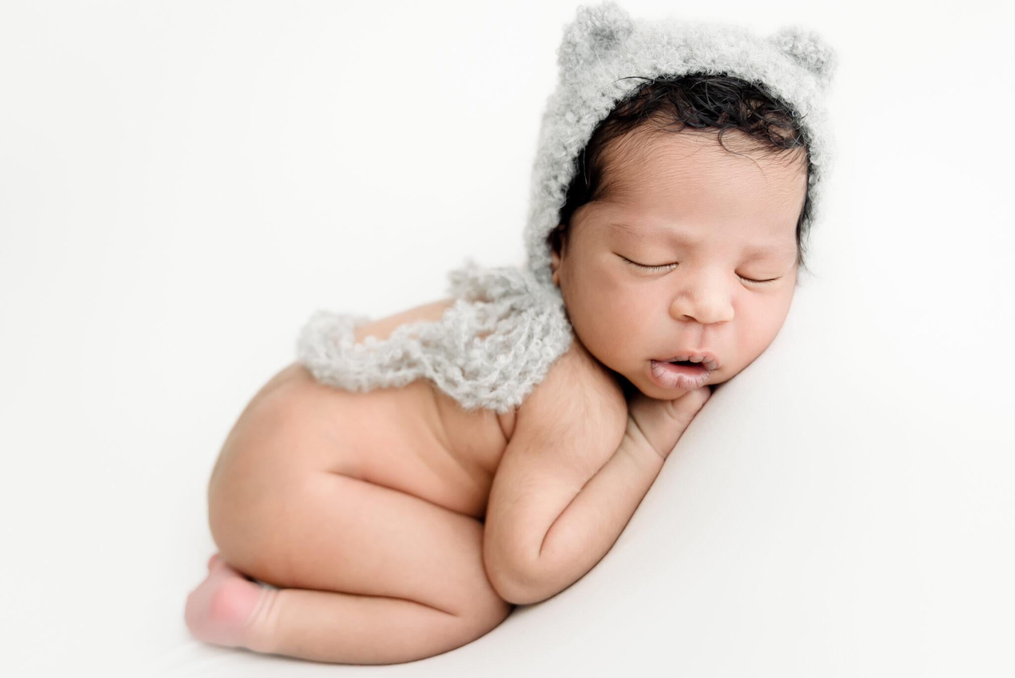Sleeping newborn baby in cute knitted hat.