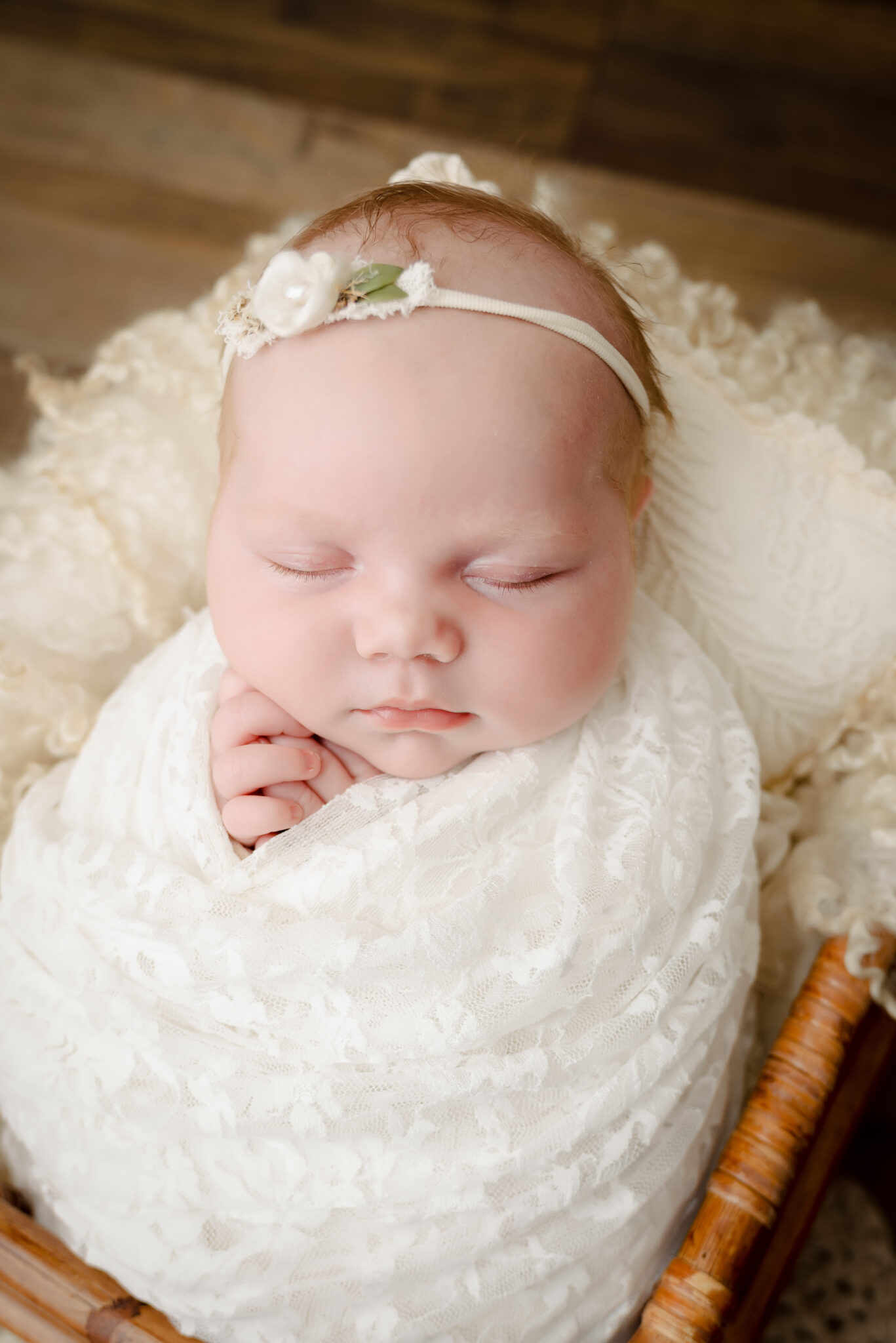Sleeping baby wrapped in lace blanket