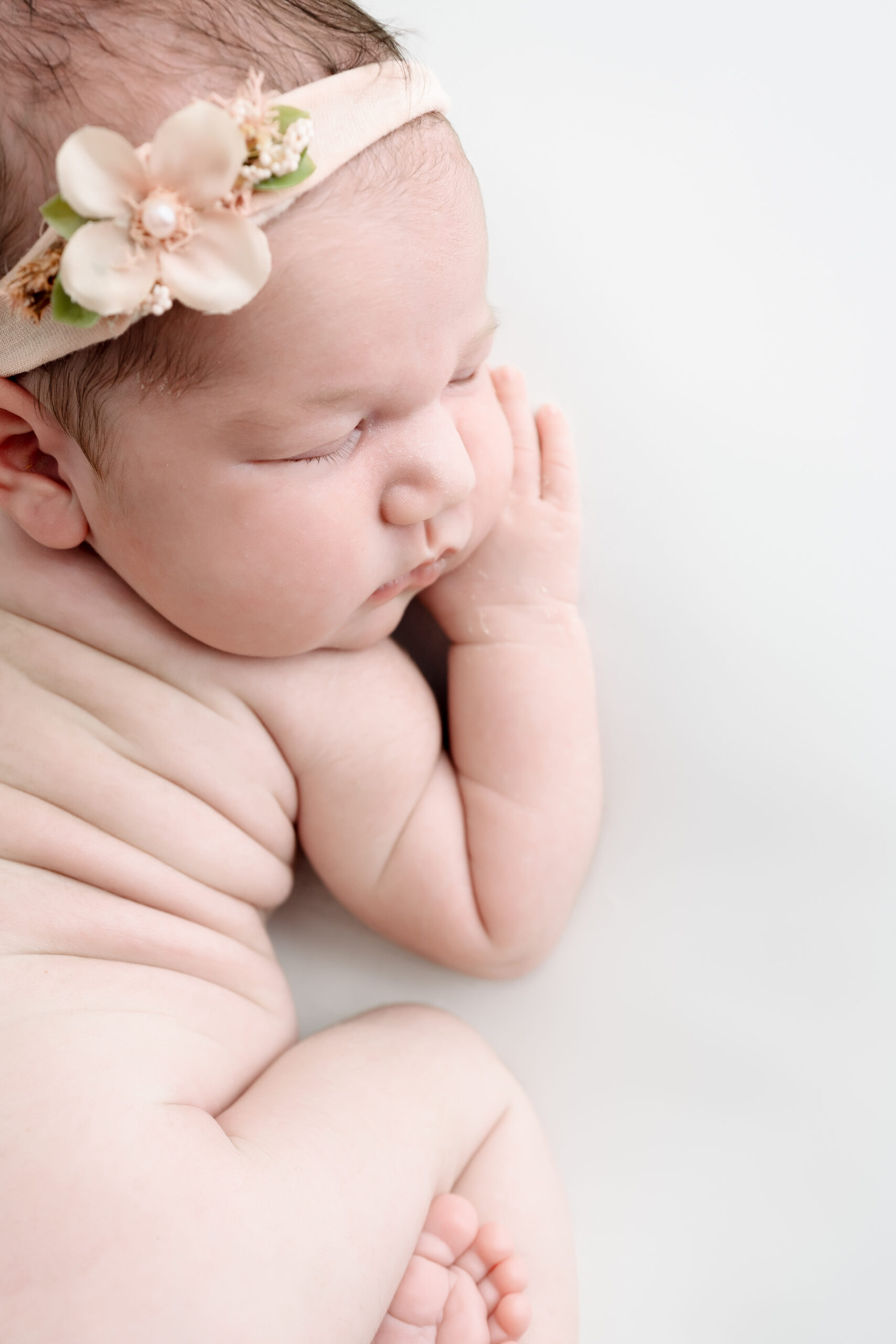 Sleeping baby with flower headband.