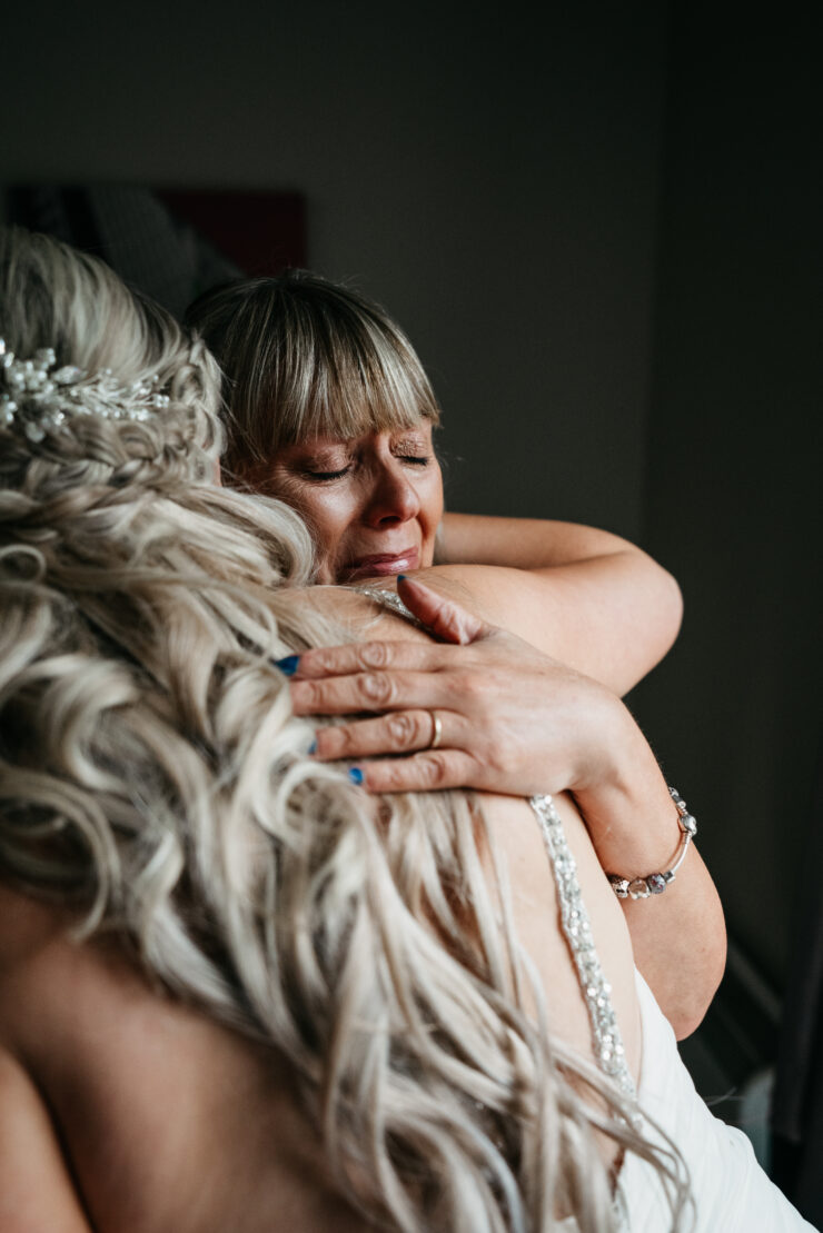 Emotional embrace at a wedding ceremony.