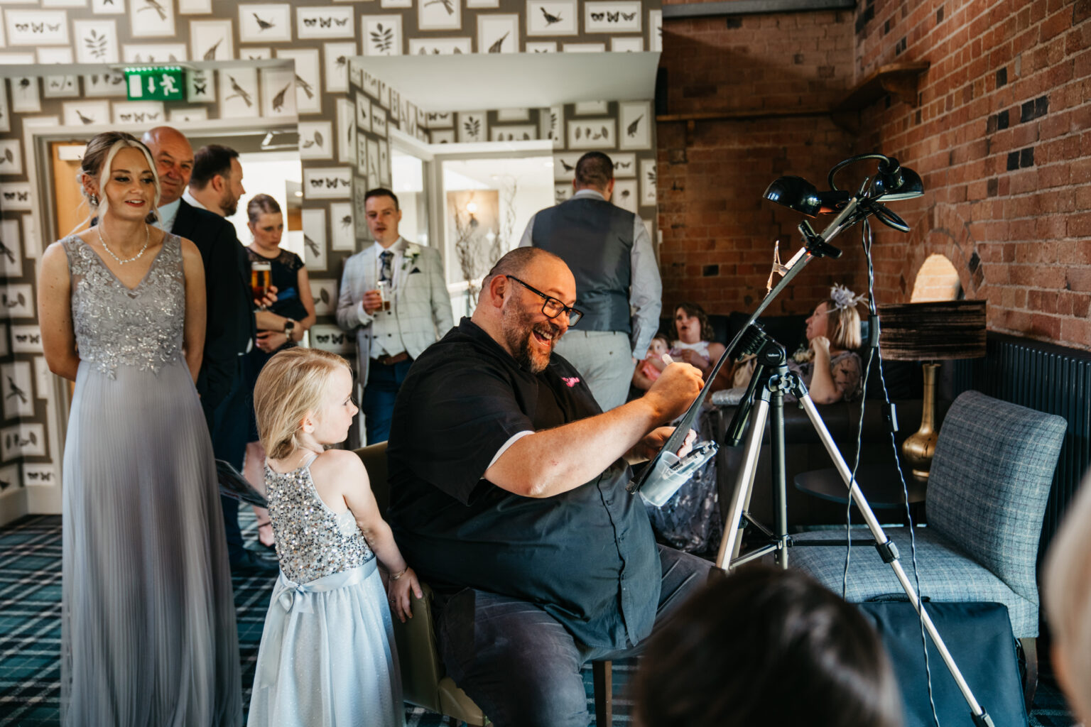 Man drawing caricature at a wedding reception.