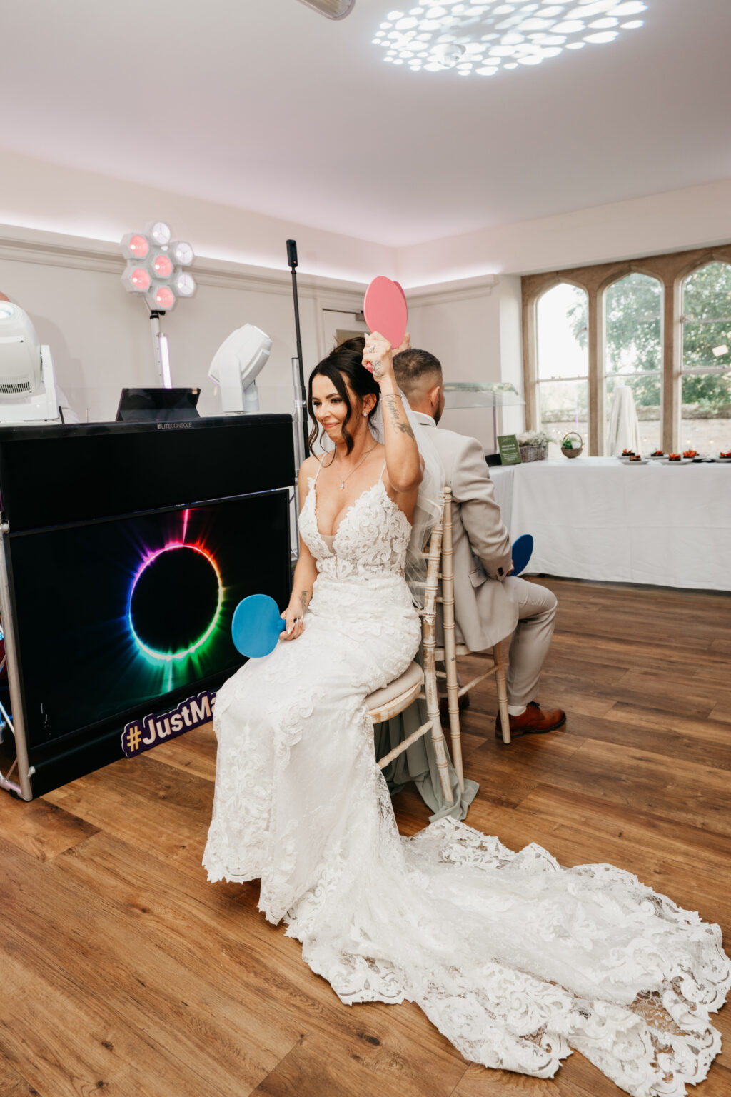 Bride and groom playing wedding game with paddles.