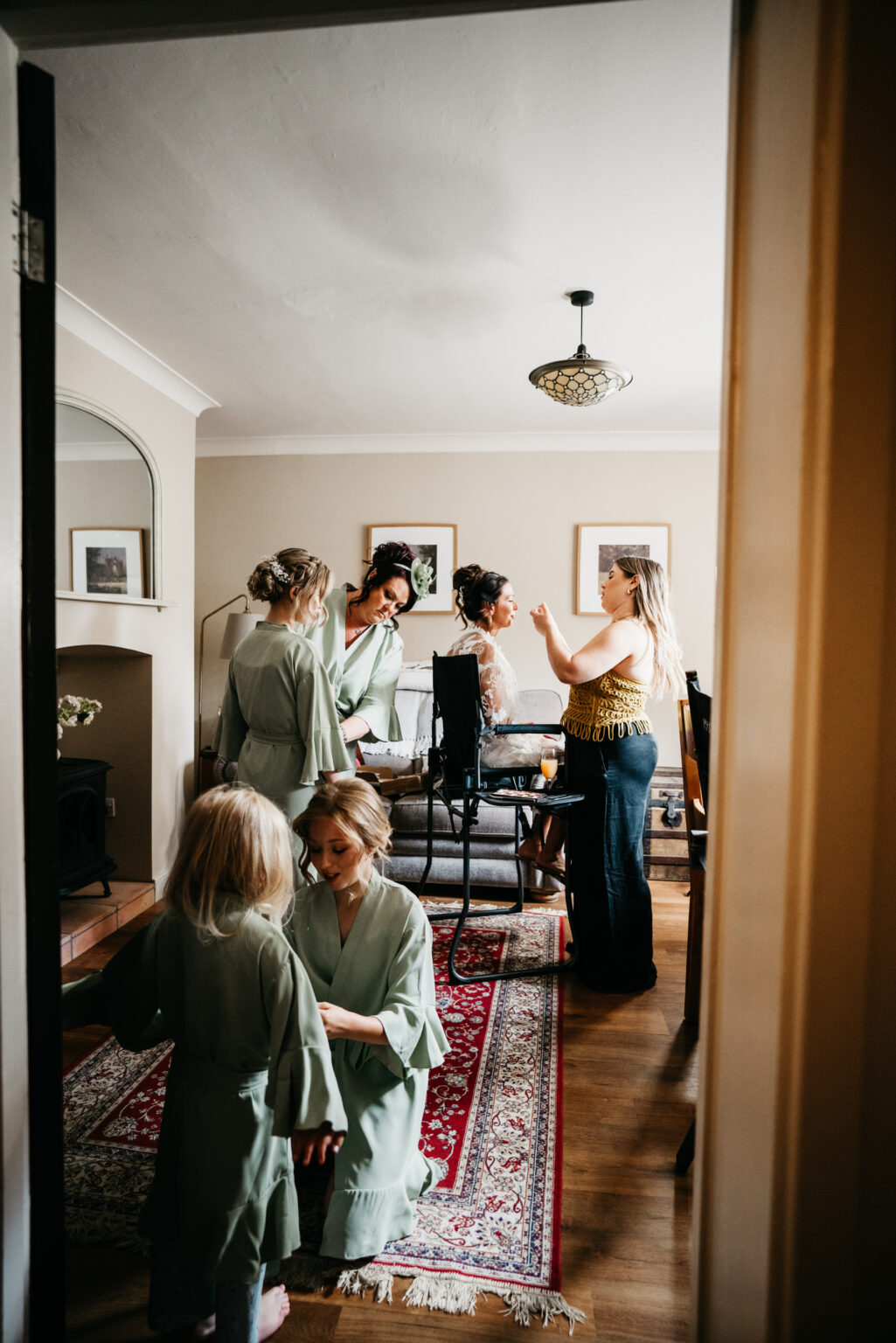 Bridesmaids preparing in living room before wedding