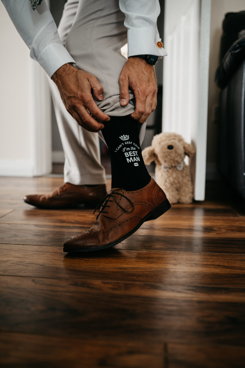 Best man adjusting socks for special event