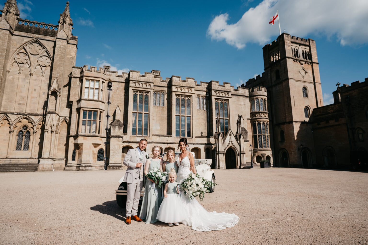 Family group outside old castle on sunny day.