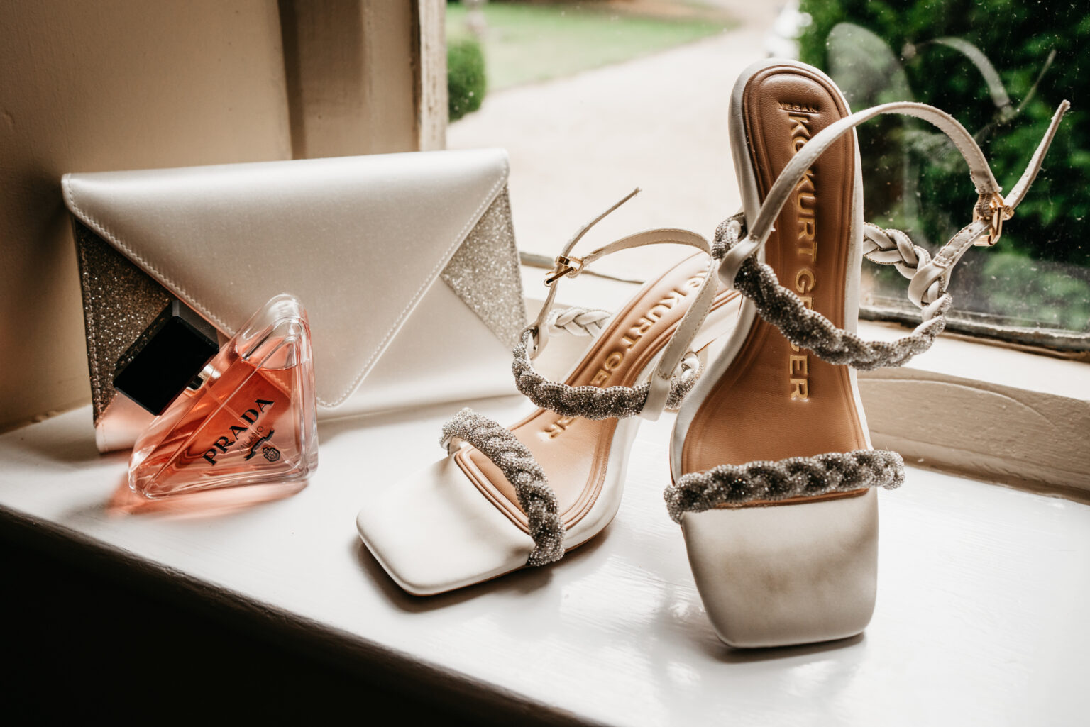 Elegant bridal accessories including shoes and perfume.