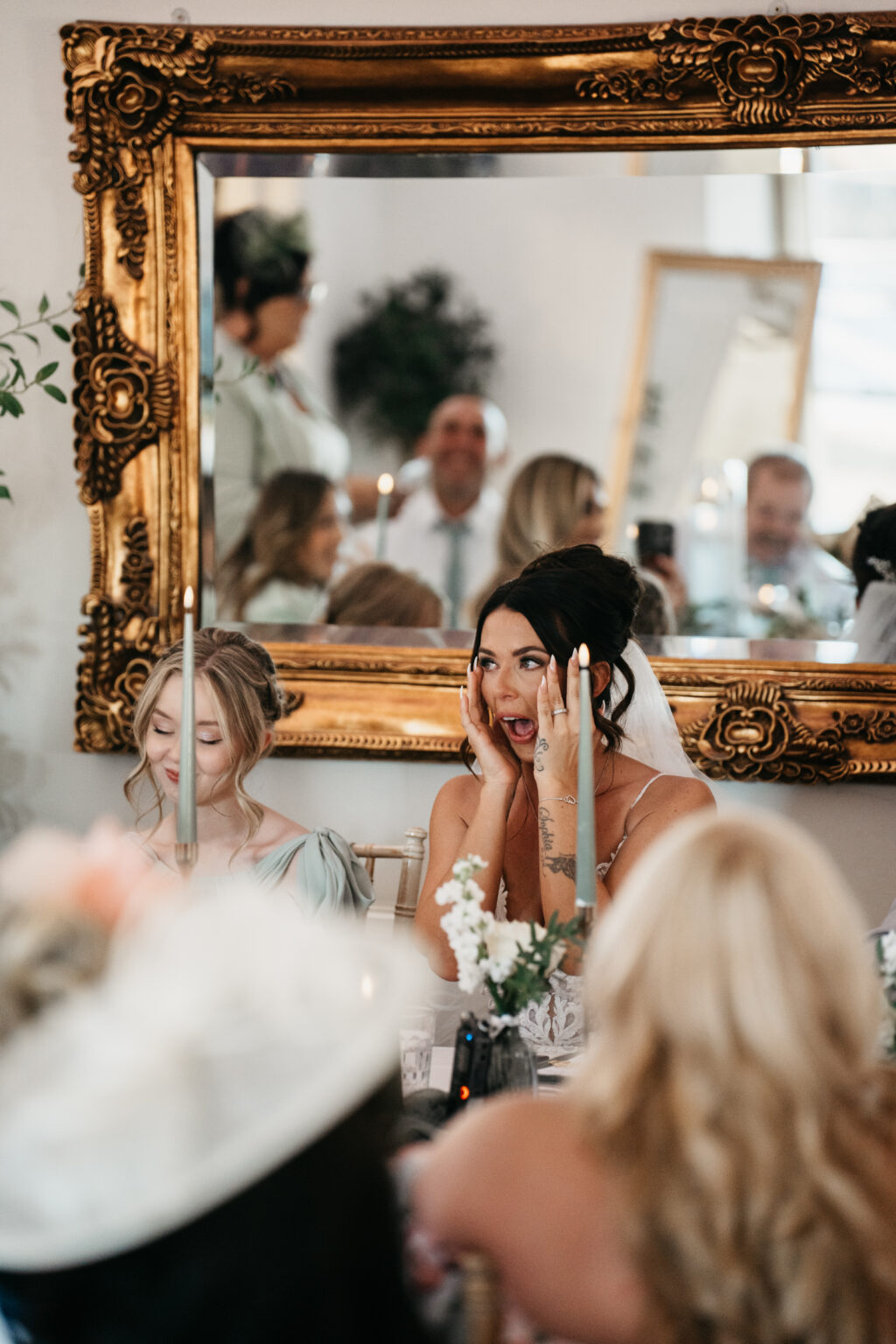 Woman reacts emotionally during wedding reception.