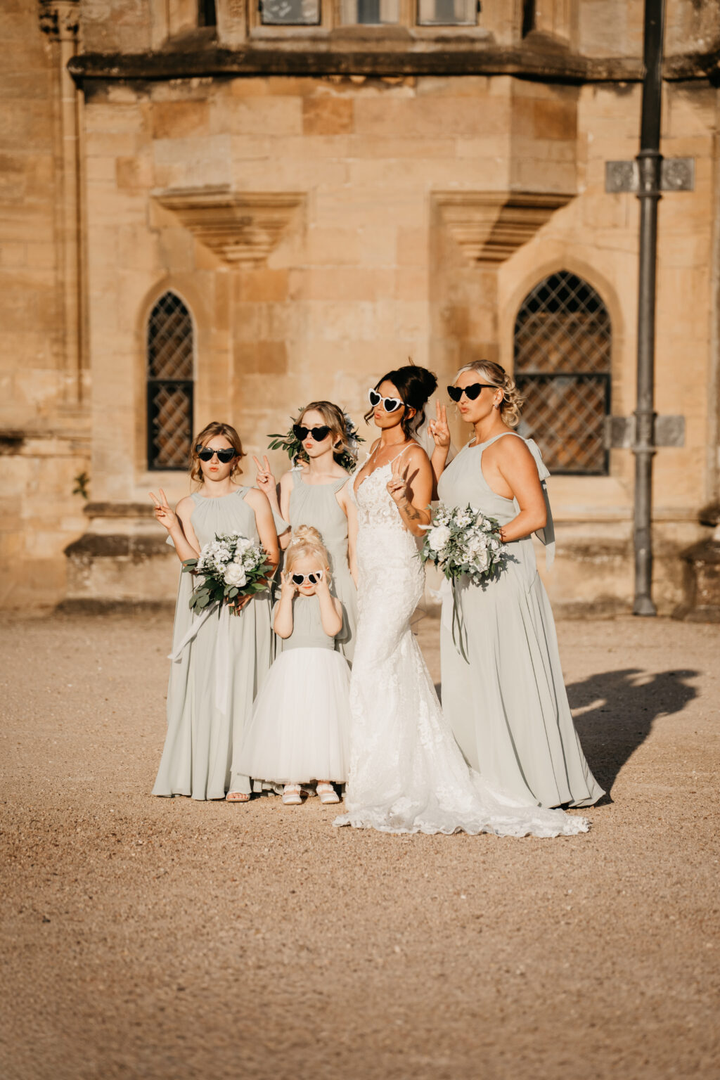 Bridal party posing with heart-shaped sunglasses.