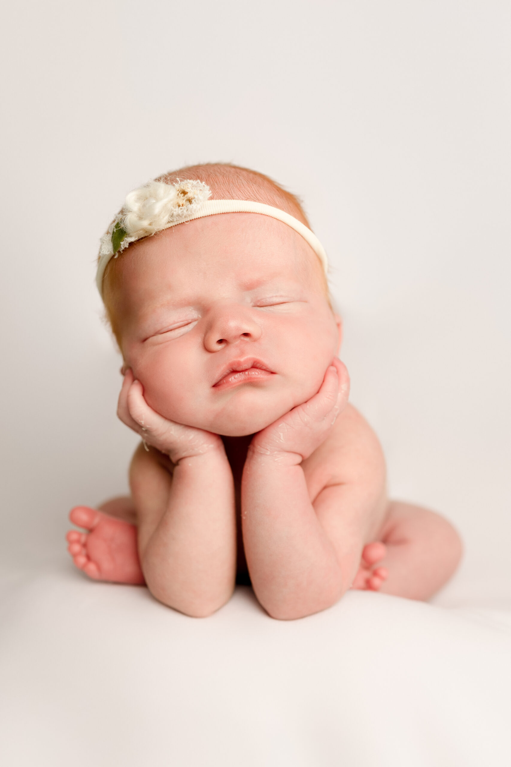 Peaceful newborn baby sleeping with headband