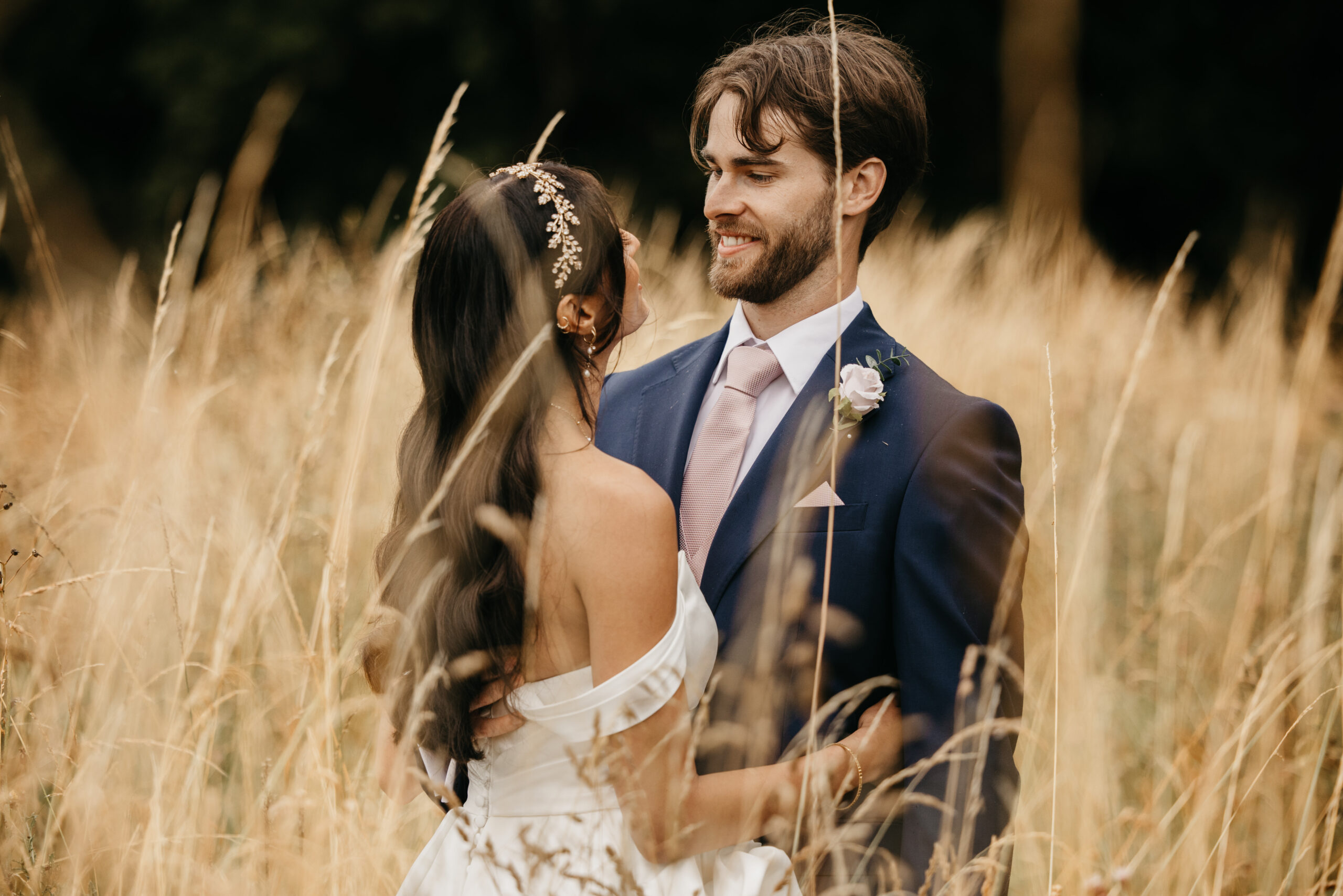 Wildes inn, chesterfield, wedding venue. Bride and groom embracing in a field.
