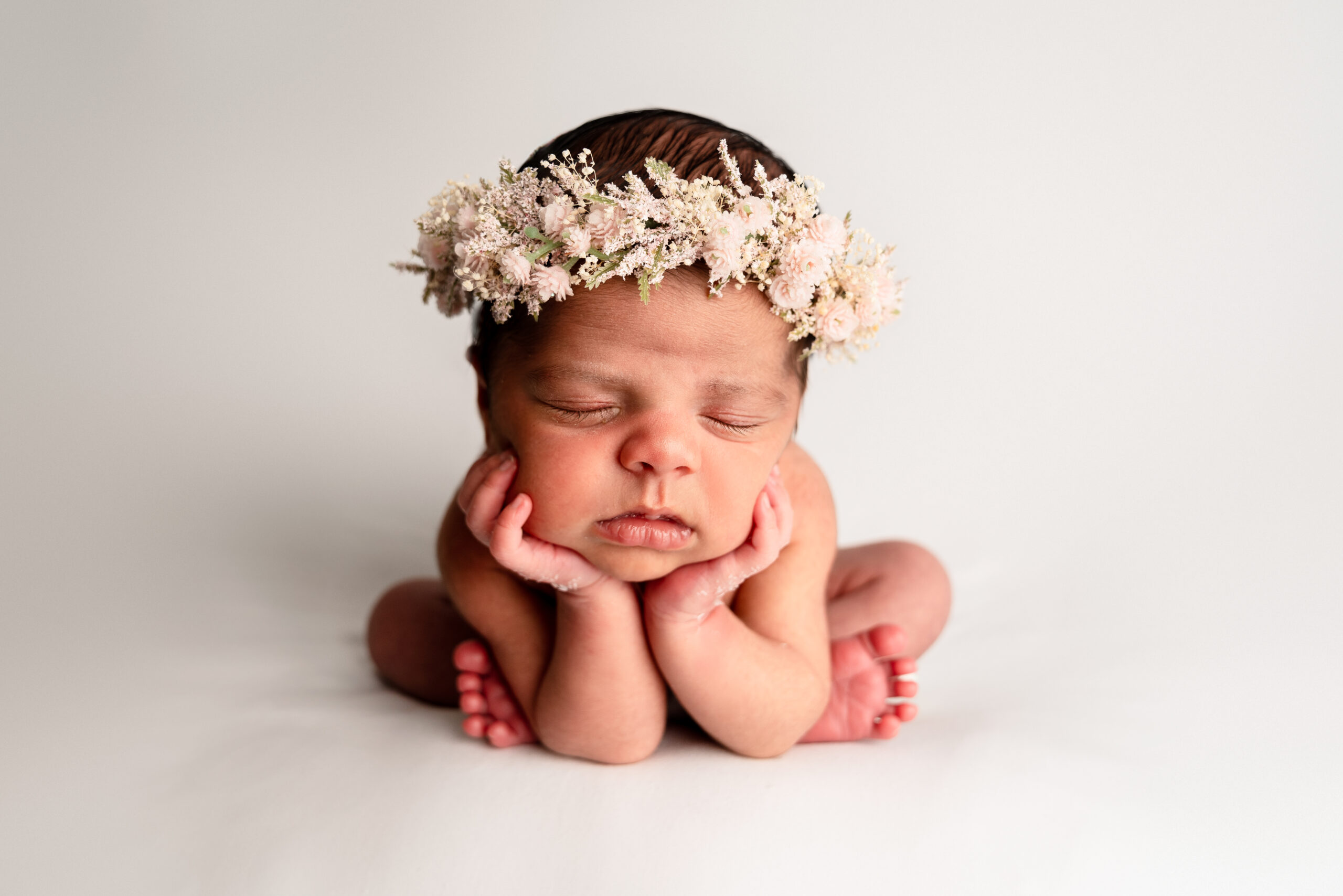 Sleeping newborn with floral headband